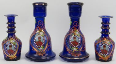 Four Persian gilt enamel painted blue glass bottles, late 19th/early 20th century. Each depicting