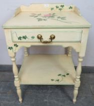 A solid oak two tier side table by Whitney furniture, hand-painted with floral motifs, the ¾ gallery