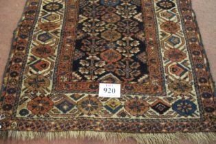 A late 19th/early 20th century Persian rug. A central block repeat pattern on black ground with