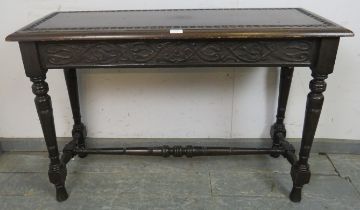 A 19th century mahogany narrow hall table in the Gothic taste, having relief carved top above an