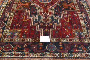 A fine North West Persian Zan Jan rug, central pattern on deep red ground with indigo spandrels.