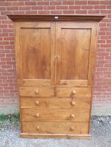 A Victorian cherry wood linen press, the moulded cornice above twin panelled doors opening onto a