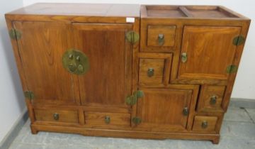 A vintage Chinese elm stepped room-divider, housing an array of six double-sided drawers and three