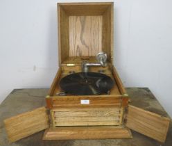 An early 20th century light oak cased tabletop gramophone by Karna, together with approximately 50