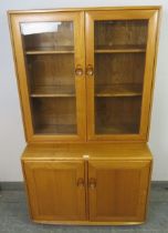 A mid-century blonde elm Windsor display cabinet/sideboard by Ercol (model 805) the bevelled glass