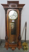 A 19th Century glazed walnut cased Vienna - type wall clock, the case of classical architectural