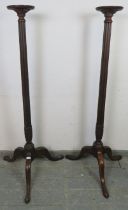 A tall pair of 19th century and later mahogany jardinières/plant stands, the dished tops above