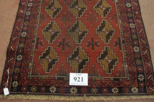 A mid 20th century Persian rug, repeat central pattern on red ground. Slight colour variation. See