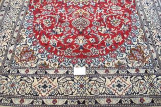 A Persian rung, central motif on red ground and wide blue & cream borders. Very clean rug. 294cm x