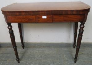 A George III mahogany turnover card table of good colour, strung with ebony, on tapered turned