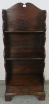 A George III mahogany ‘waterfall’ narrow bookcase of three graduated open shelves, above one long
