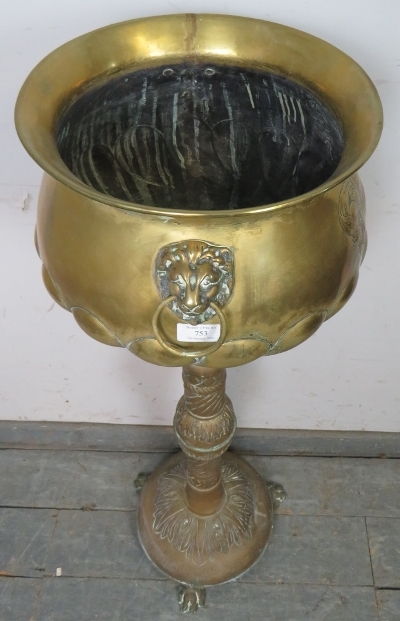 An antique brass pedestal jardinière planter, having relief decoration depicting an armorial crest - Image 2 of 3