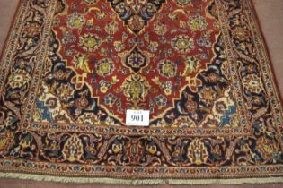 A fine central Persian Kashan rug. Central floral design blue on red ground. In very good condition.