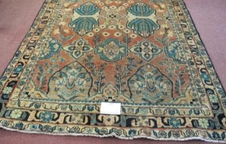A North West Persian Heriz rug. Central panels depicting flowers/foliage on pale pink ground.