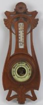 An Art Nouveau carved oak barometer, early 20th century. Incorporated with a mercury thermometer.