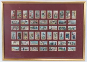 A framed set of John Player & Sons ‘Man of War in 1805 and 1905’ cigarette cards. Mounted, framed