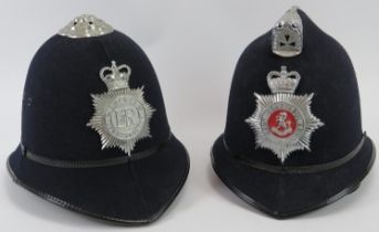 Two vintage British Police helmets, 20th century. Sussex and Kent Constabulary. (2 items). Condition