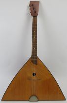 A wooden three string Balalaika, 20th century. 67.5 cm length. Condition report: Some wear with age.