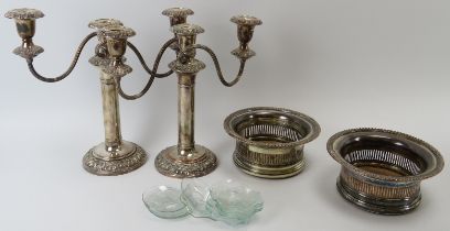 A pair of plated silver wine coasters and a pair of plated silver candelabra. (4 items)