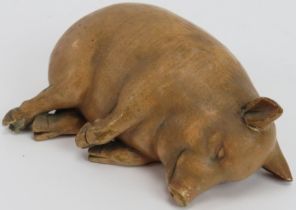 A rare vintage ceramic piggy bank, possibly French. Modelled as a recumbent sleeping pig.