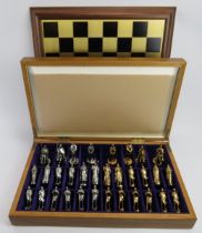 A Medieval themed cast metal chess set and board, late 20th century. 10.2 cm tallest height.