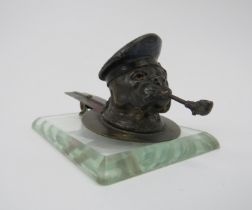 A vintage cold painted metal pipe smoking bulldog paperclip, early 20th century. Supported on a