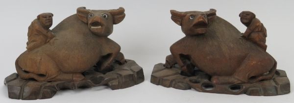 A pair of Chinese carved hardwood buffalo groups, early 20th century. Both carved depicting a figure