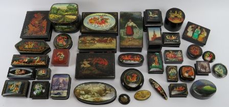 Collection of thirty six Russian lacquer papier Mache boxes, hair slides, brooches, some signed. (36