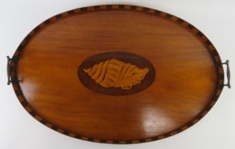 An Edwardian Sheraton Revival twin handled oval tray. The centre marquetry inlaid with a shell