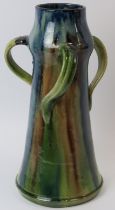 A Belgian drip glazed pottery jug, late 19th/early 20th century. In the form of a flagon with