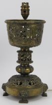 An ecclesiastical brass chalice table lamp, 19th century. Later converted into a table lamp. 33 cm