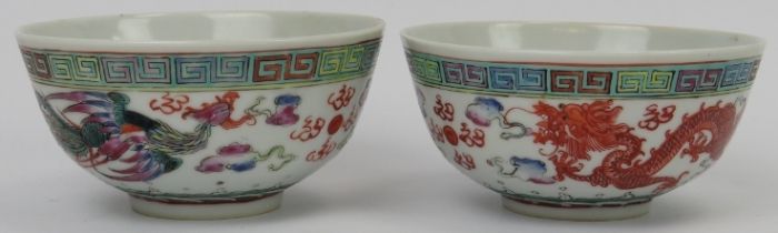 Two Chinese enamelled porcelain bowls, 20th century. Each painted with a confronting dragon and