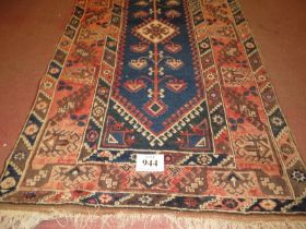 A 20th Century Turkish Dosemalti rug, central motif on blue ground and wide pale red borders,