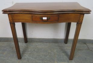 A George III mahogany serpentine fronted turnover tea table, the single drawer with parquetry inlay,