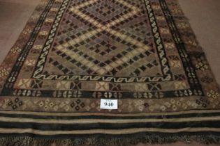 A 20th century Kilim rug with a diamond arrangement pattern to the main body and on brown/cream