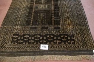 A 20th century Turkoman rug. Central pattern on brown ground and intricate repeat border. 186cm x