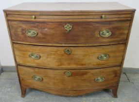 A George III mahogany bow-fronted chest with reeded edge, having a pull-out brushing slide over