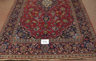 Central Persian Kashan rug. Central motif and foliage on a red ground, with blue spandrels and