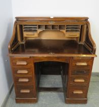 An Art Deco walnut 'S-type' roll-top desk, of usable proportions, the tambour door opening