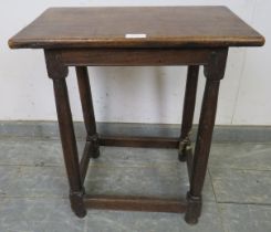An 18th century joint stool, the loose mahogany top on plain turned oak supports united by