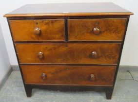 A 19th century flame mahogany chest of two short over two long graduated drawers with turned