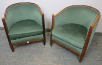 A pair of French Art Deco Period tub chairs, the tapered fluted front supports with domed finials,