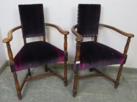 A pair of antique Continental fruitwood elbow chairs, reupholstered in rich purple velvet with