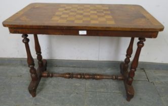 A Victorian walnut inlaid chess table, the crossbanded top with marquetry decoration depicting