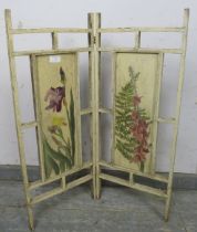 A small antique two-section folding screen, the inset panels with hand-painted foliate decoration.