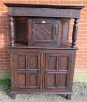 A 17th century and later oak court cupboard, the top section with central cupboard flanked by relief