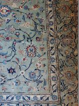 A large Persian carpet, a central block overall pattern on a pale blue ground with foliage and