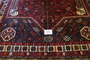 A fine South West Persian Qashqai carpet central blue motif on a deep red ground. Good quality, deep