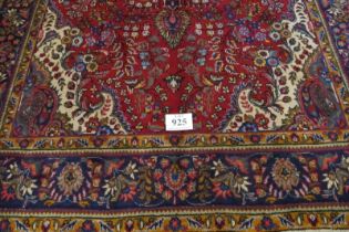 North west Tabriz carpet, central motif on a deep red ground and wide blue border. 305cm x 200cm (