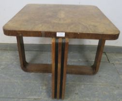 An Art Deco Period walnut occasional table, the quarter veneered top on interlocking curved supports